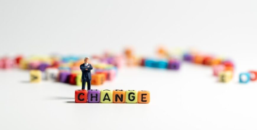 miniature-figure-businessman-dark-blue-suit-standing-backside-colorful-change_41689-511-870x440